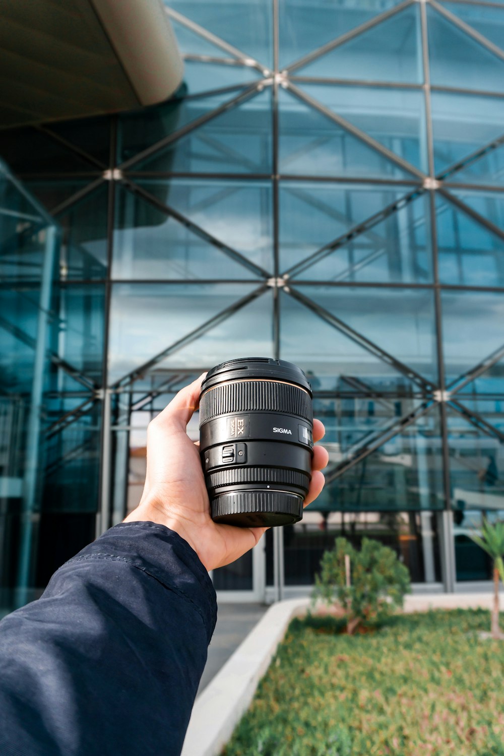 person holding camera lens