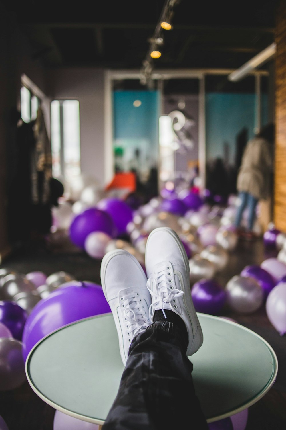 person wearing white sneakers in room