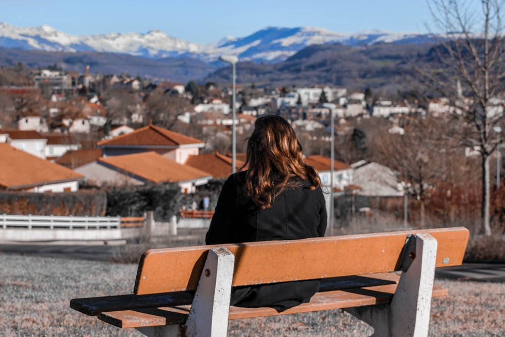 woman sitting on bench during daytime