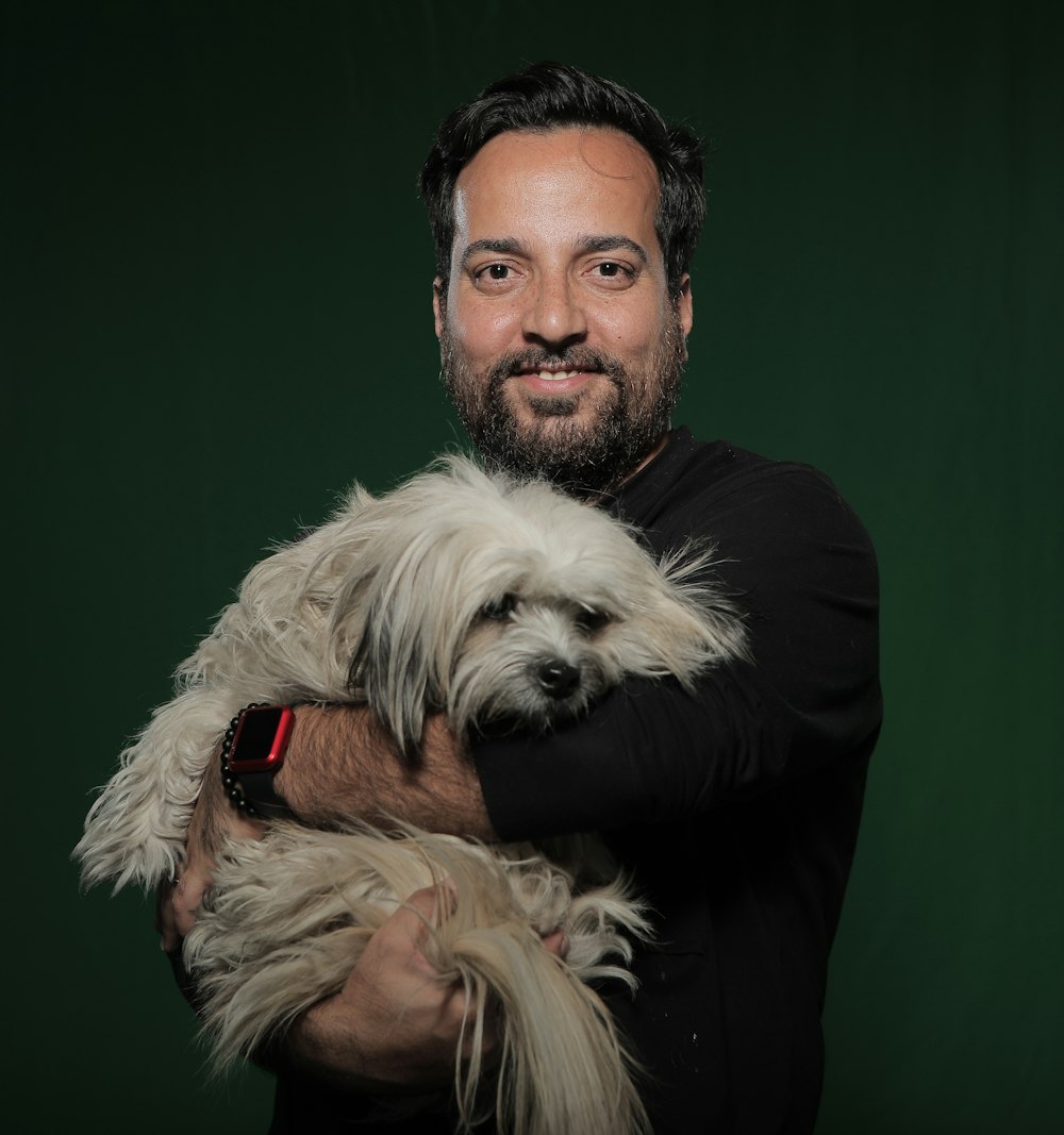 man holding white dog