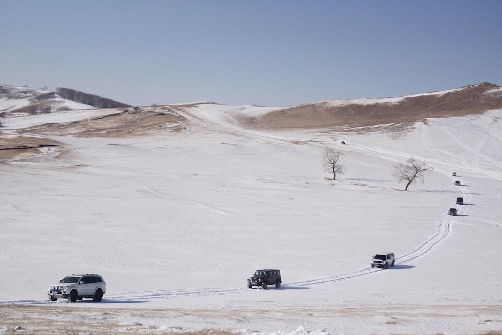 group of vehicles on white sand