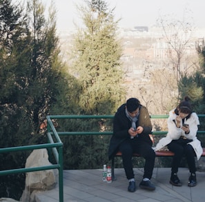 man sitting on brown bench