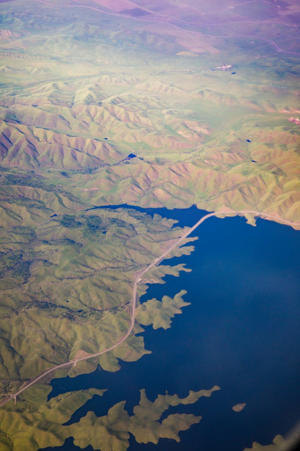 mountains beside body of water in aerial view photography