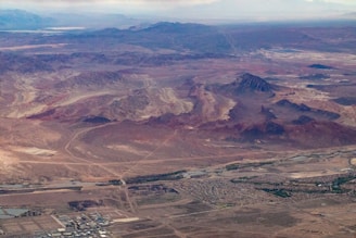 A professional surveyor using a drone to map a vast desert landscape in Saudi Arabia.