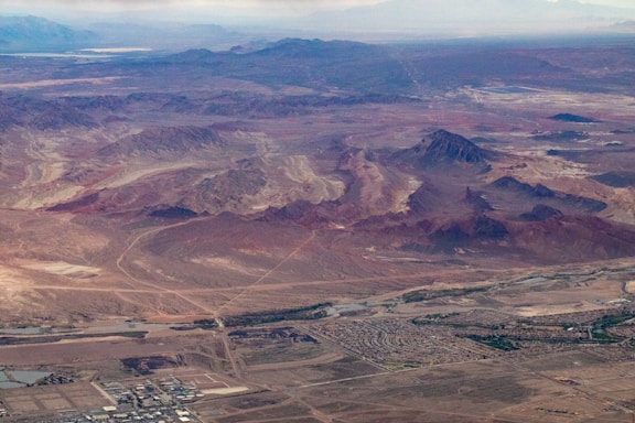 A professional surveyor using a drone to map a vast desert landscape in Saudi Arabia.