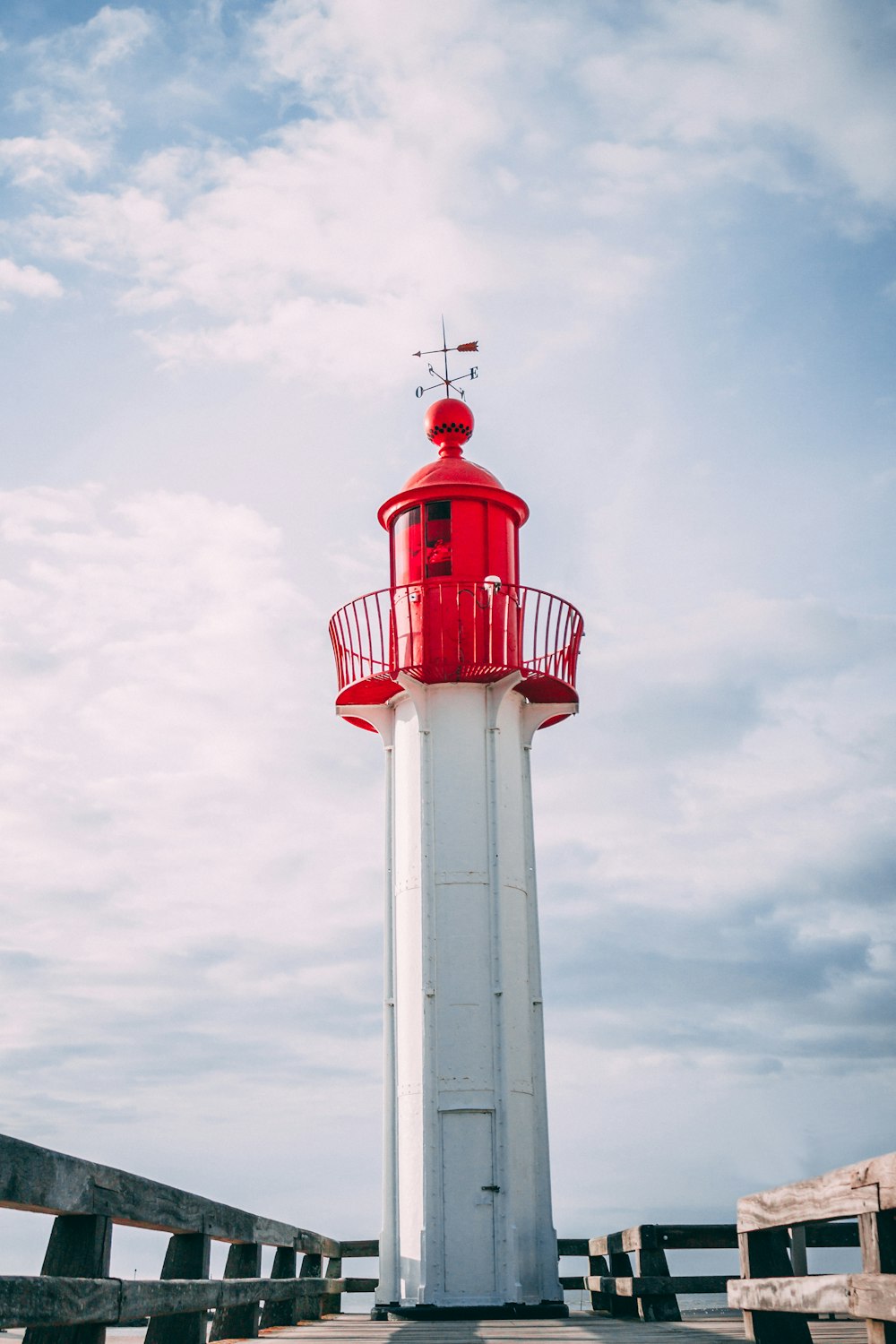 white and red lighthouse on dockside
