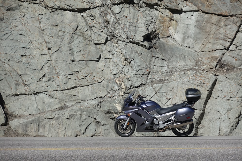 gray sportbike park near stone wall