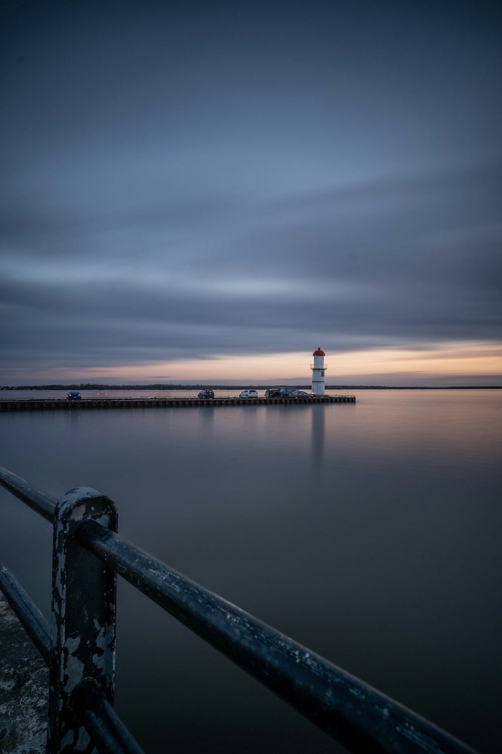 white lighthouse near body of water