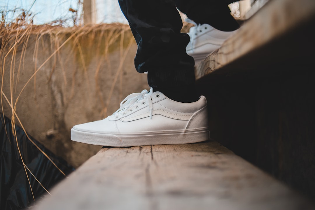 person wearig white Vans low-top sneakers