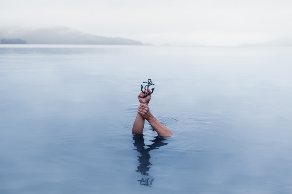 person underwater holding anchor scale model