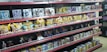 Shelves filled with various toy figurines and boxed sets, organized neatly. The figurines, mostly golden and shiny, depict various characters in dynamic poses. The boxed sets include colorful and detailed packaging featuring imagery of the characters. The overall arrangement is orderly, displaying a collection of collectibles.