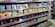 Shelves filled with various toy figurines and boxed sets, organized neatly. The figurines, mostly golden and shiny, depict various characters in dynamic poses. The boxed sets include colorful and detailed packaging featuring imagery of the characters. The overall arrangement is orderly, displaying a collection of collectibles.
