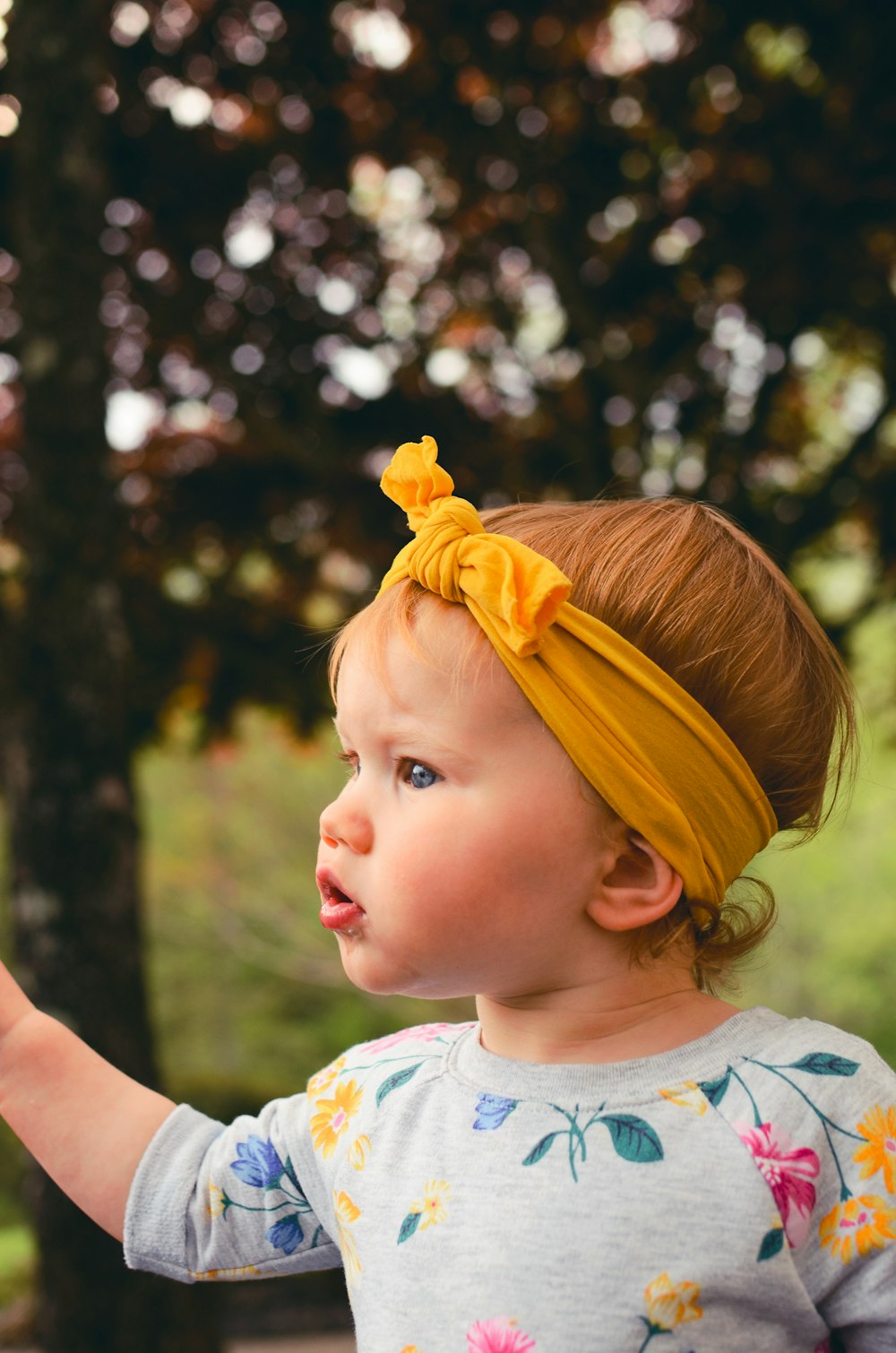 girl wearing gray shirt and yellow headband