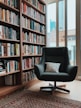 gray fabric padded rolling armchair near books