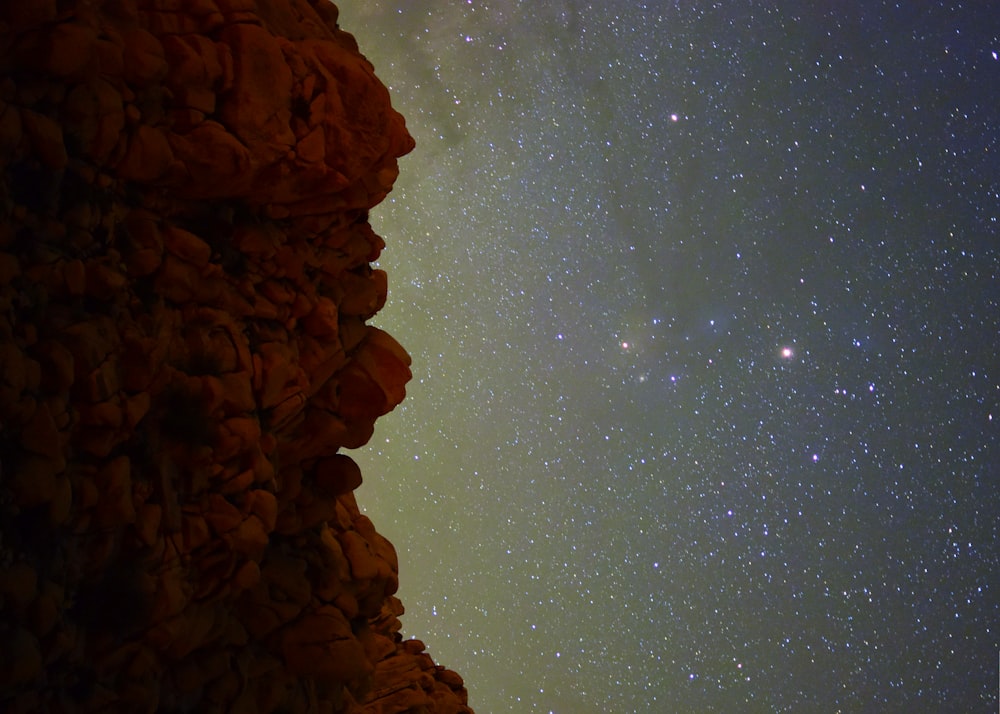 rock formation under sky with stars