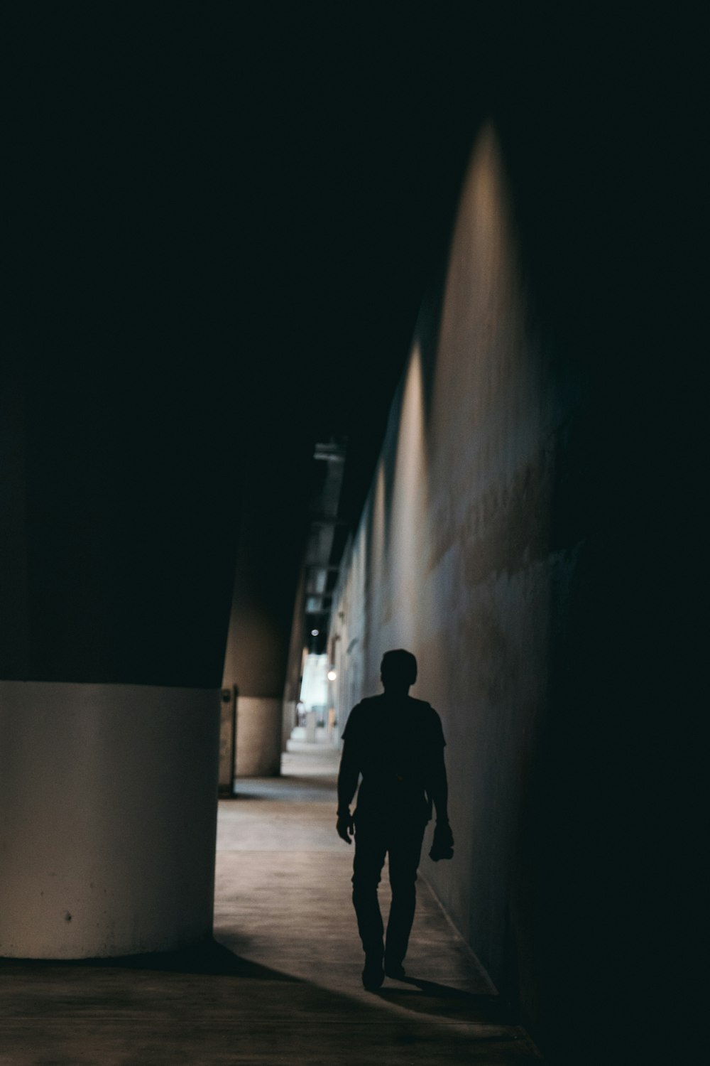 a man under a dark bridge