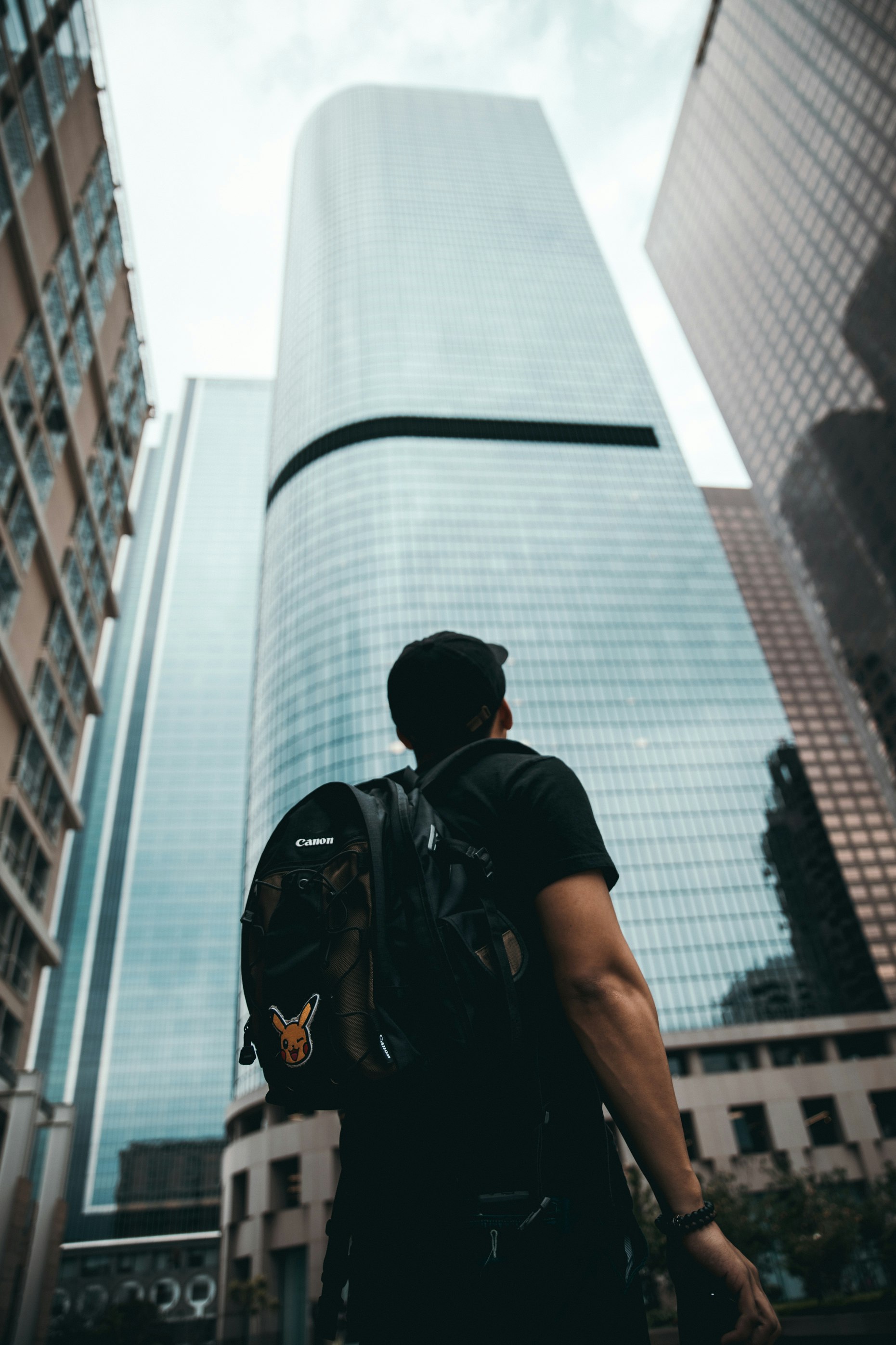 man standing near high rise buildings