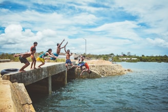 Children laughing as they prepare to jump into an icy lake after a sauna session.