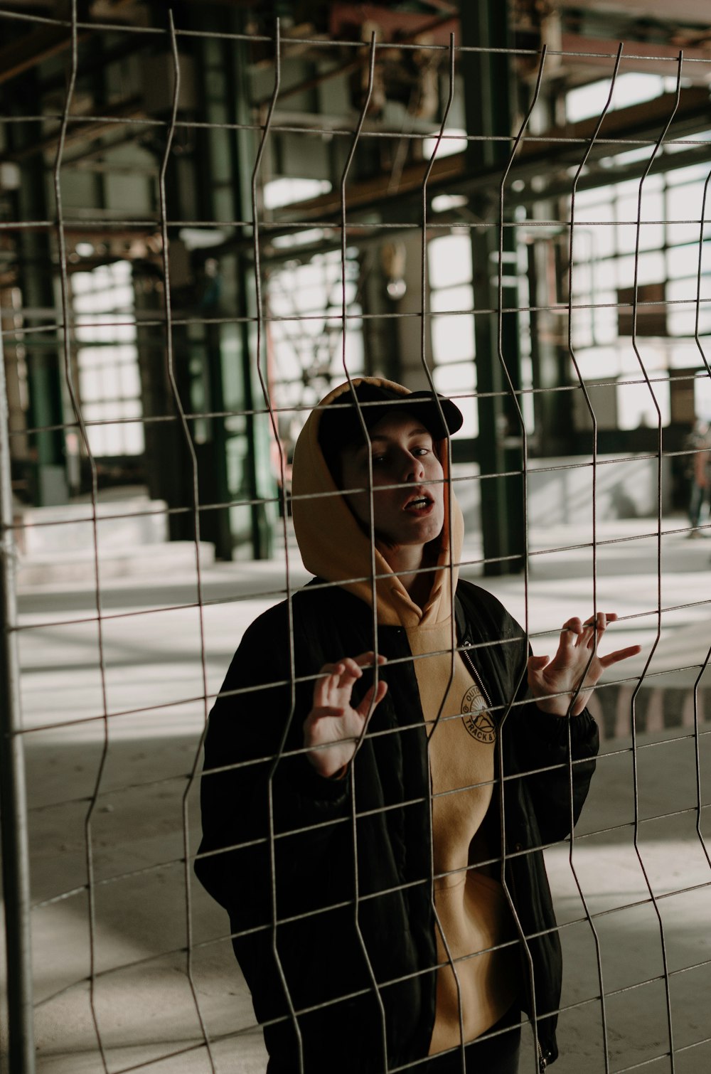 man holding on fence