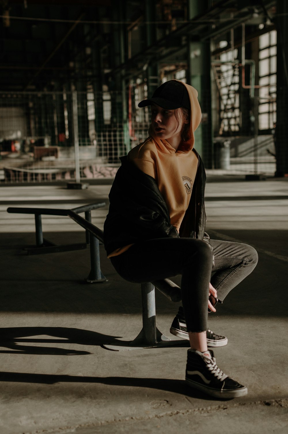 woman sits on skate rail