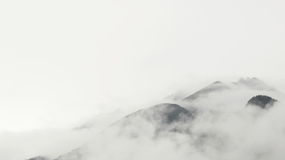 a mountain covered in fog and low lying clouds