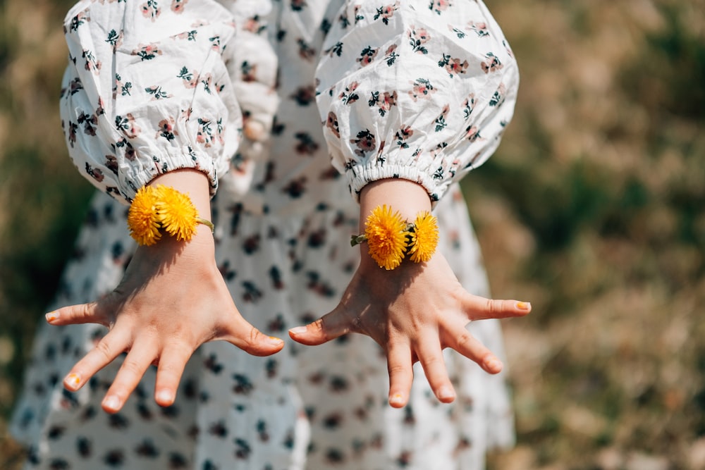 person showing orange petaled flower bracelet