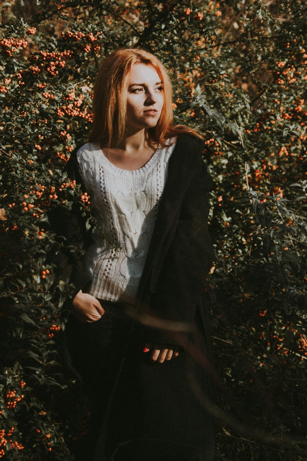 woman in white cable knit shirt wearing black jacket