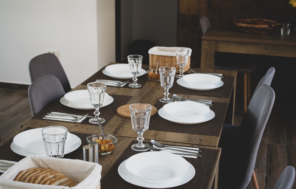 brown wooden table on white ceramic plates