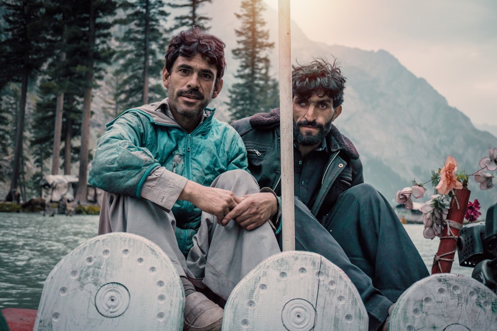 two men sitting on boat