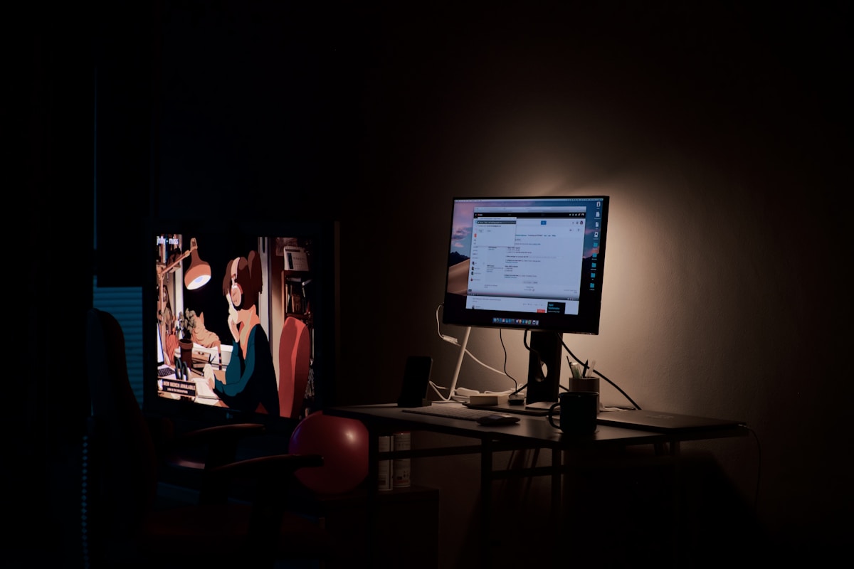 Dark monitors showing financial data representing QARI's learn hub