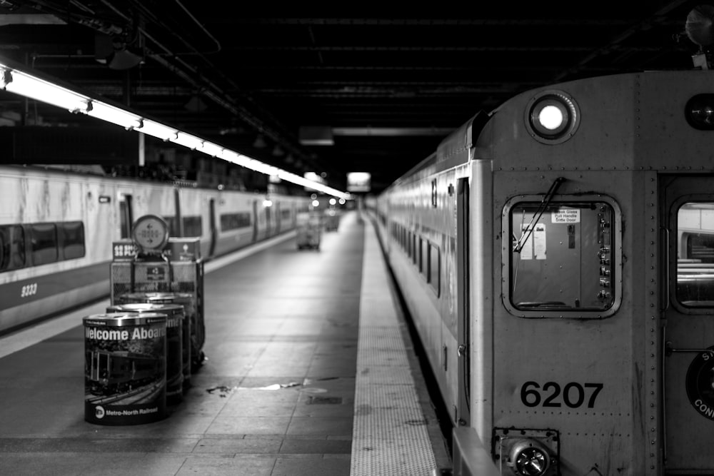 a black and white photo of a train at a train station