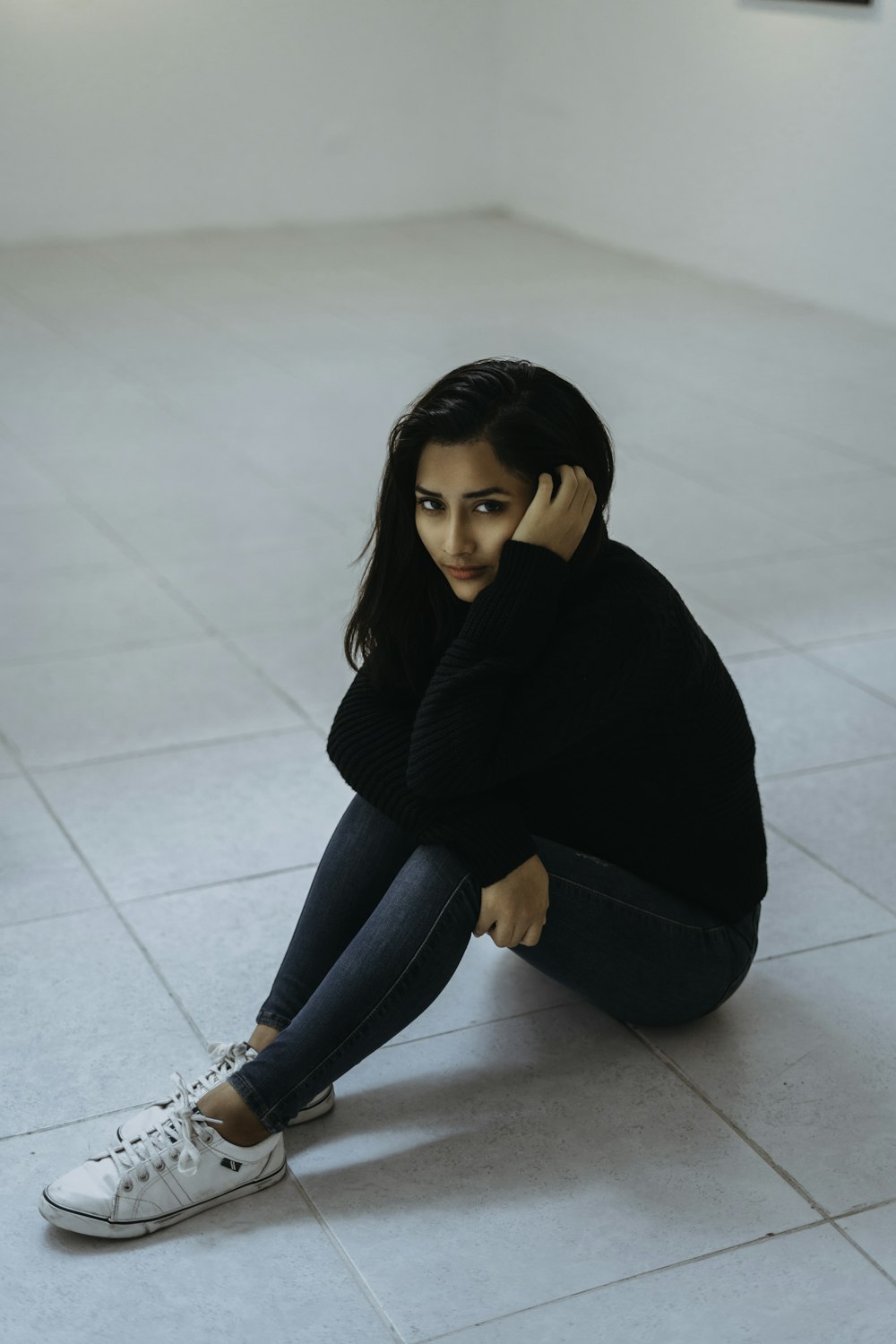 woman sitting on white floor tile