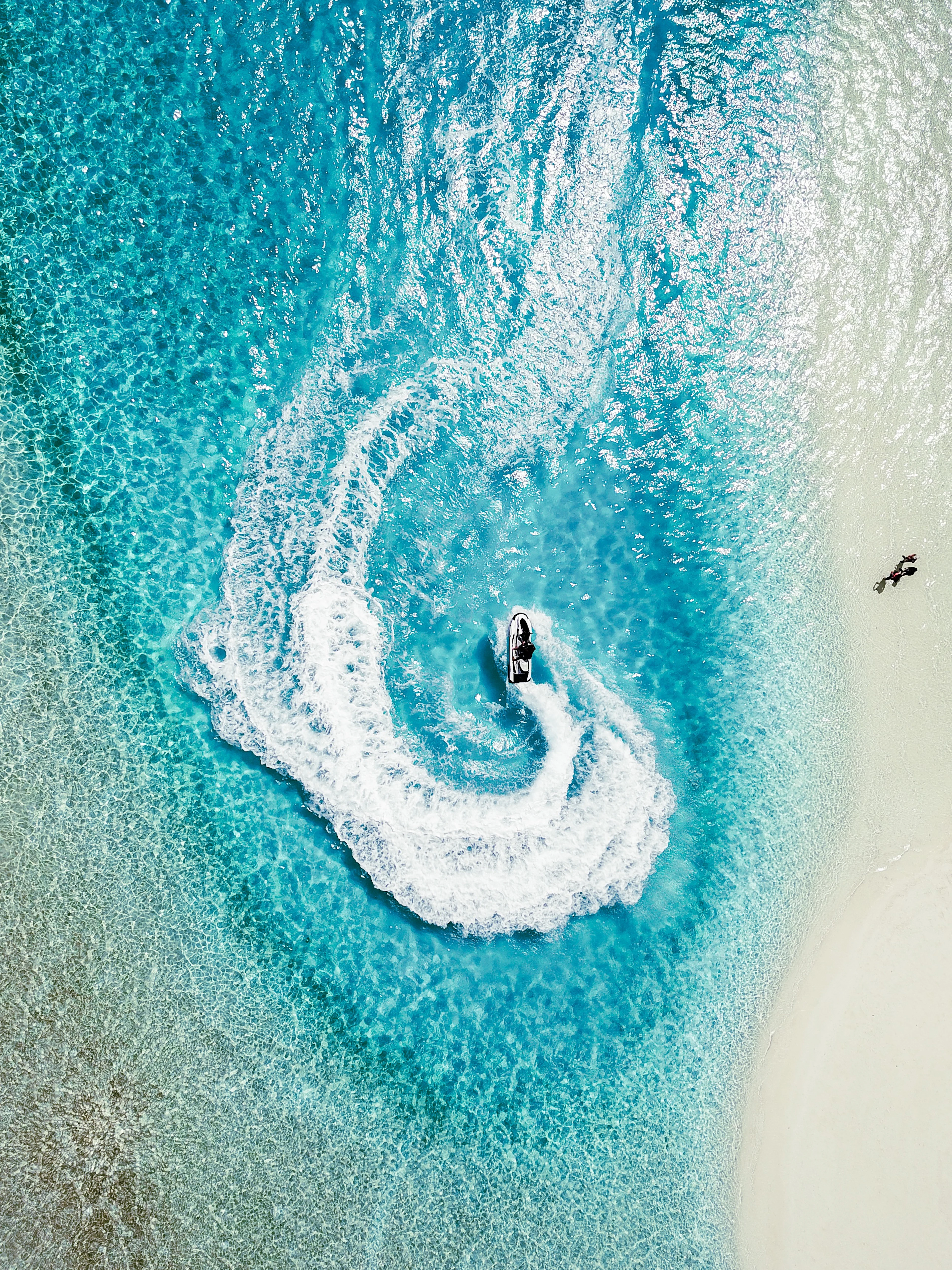 Jet ski carving a turn with a spray of water
