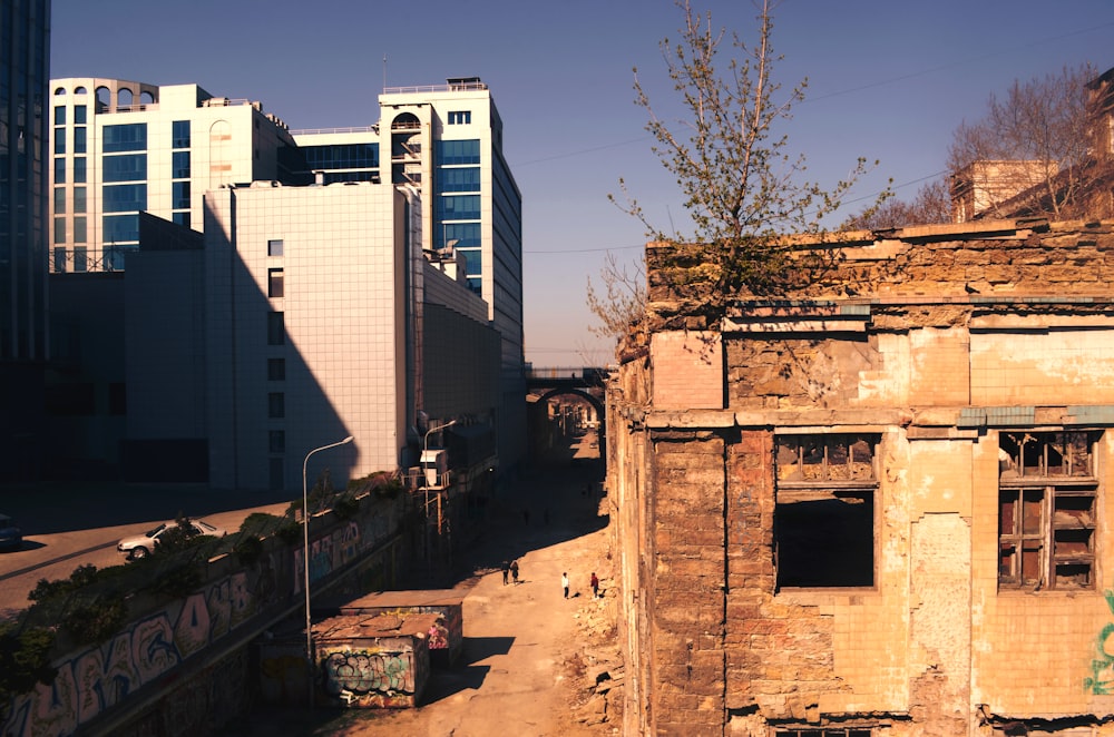 wrecked building beside new build building