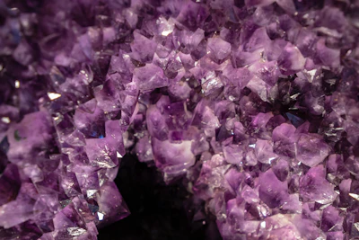 a close-up of microscopic crystalline textures shimmering with a hint of neon violet