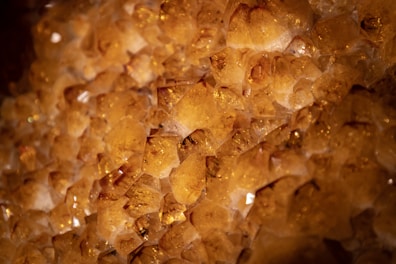 Bright citrine crystals catching sunlight on a natural rock