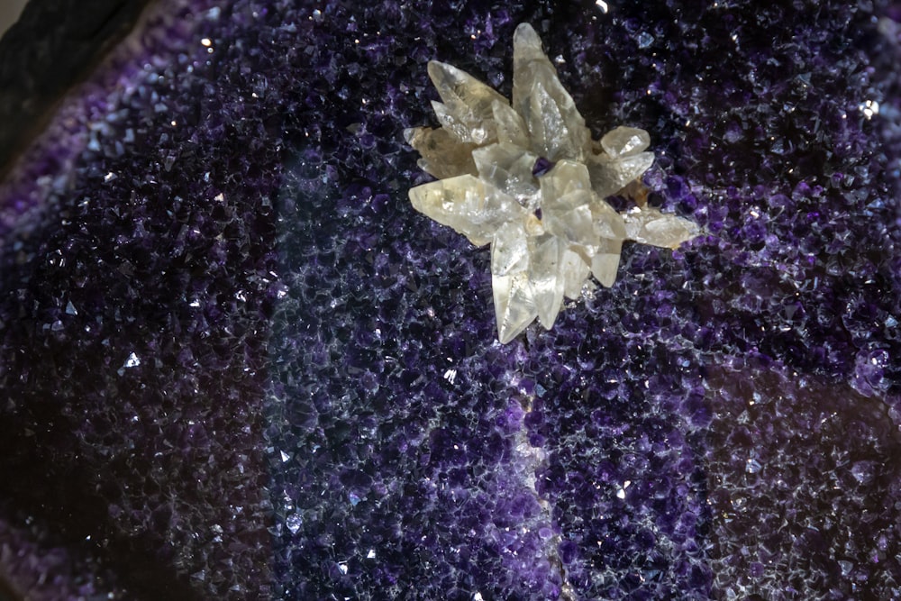 a cluster of crystals sitting on top of a purple surface