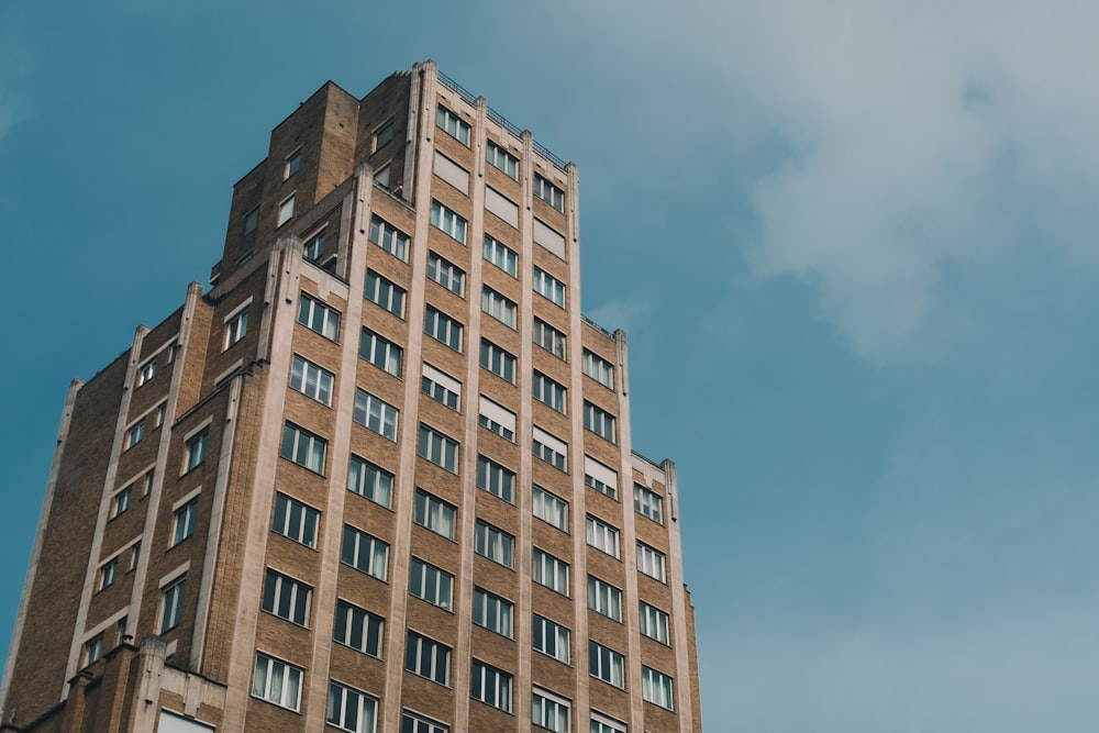 low-angle photo of brown high-rise building during day time