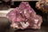 Close-up of natural crystals glowing softly under ambient purple lighting.