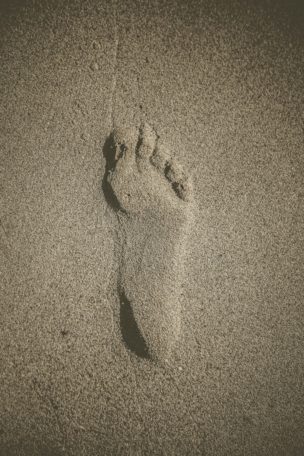 person foot print on sand
