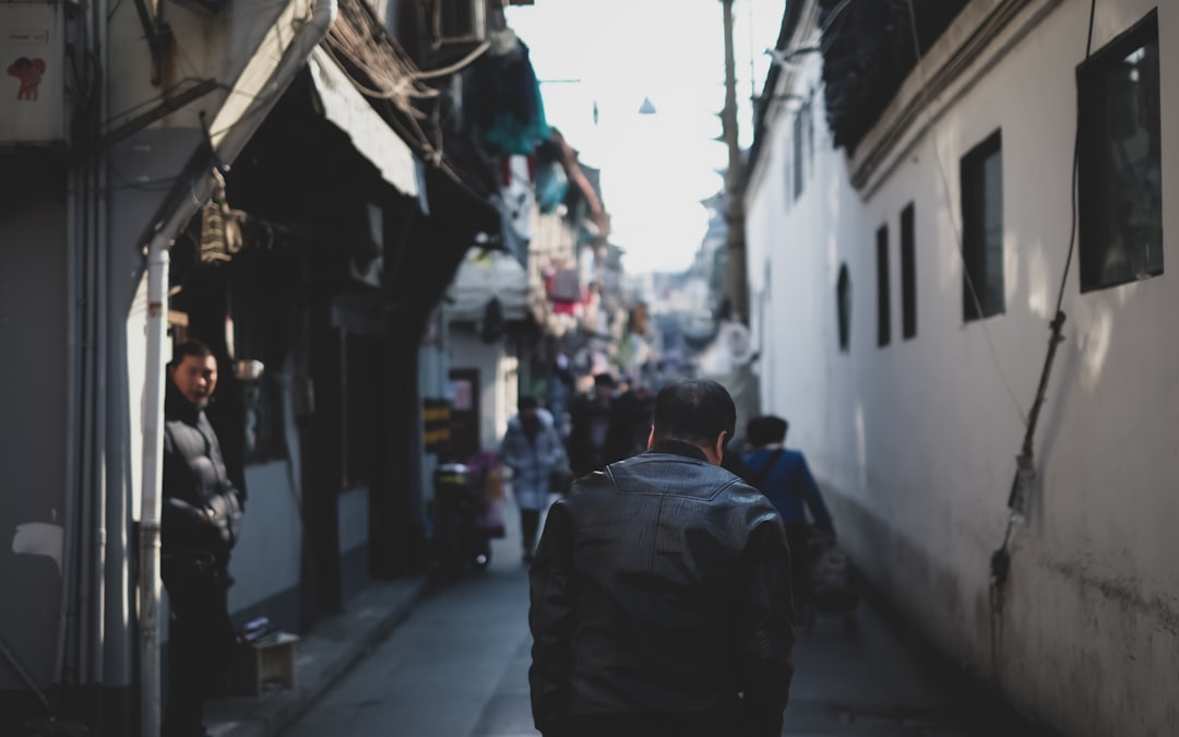 man walking on road during daytime