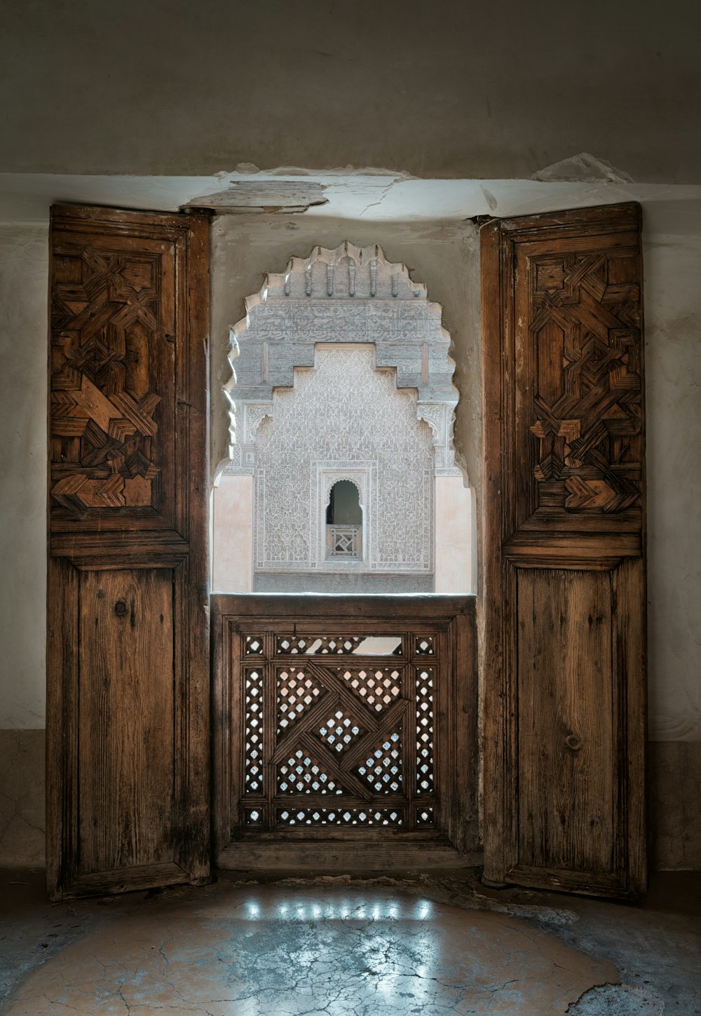 a wooden gate with a window in the middle of it