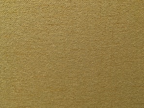 A close-up view of a textured fabric with a tightly woven pattern. The fabric appears to have a rough surface with visible threads in a uniform grid layout.