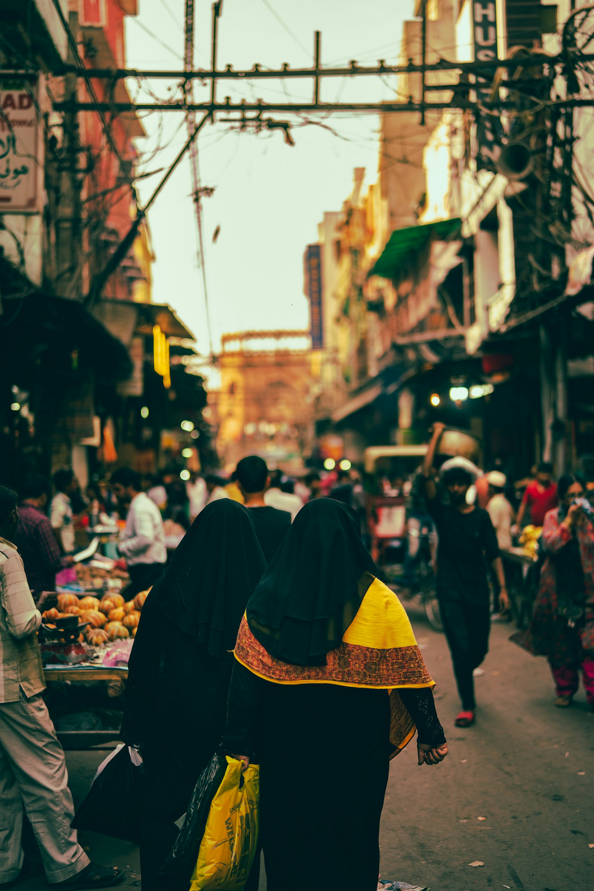 people walking between buildings