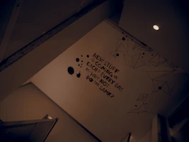 Elegant black and white motivational wall art showing daily goals stripes, placed on a modern desk