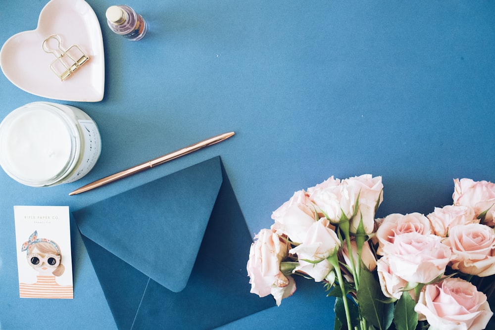 blue envelope beside roses