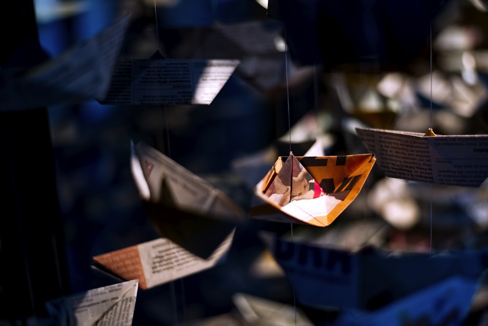 a group of paper boats floating in the air