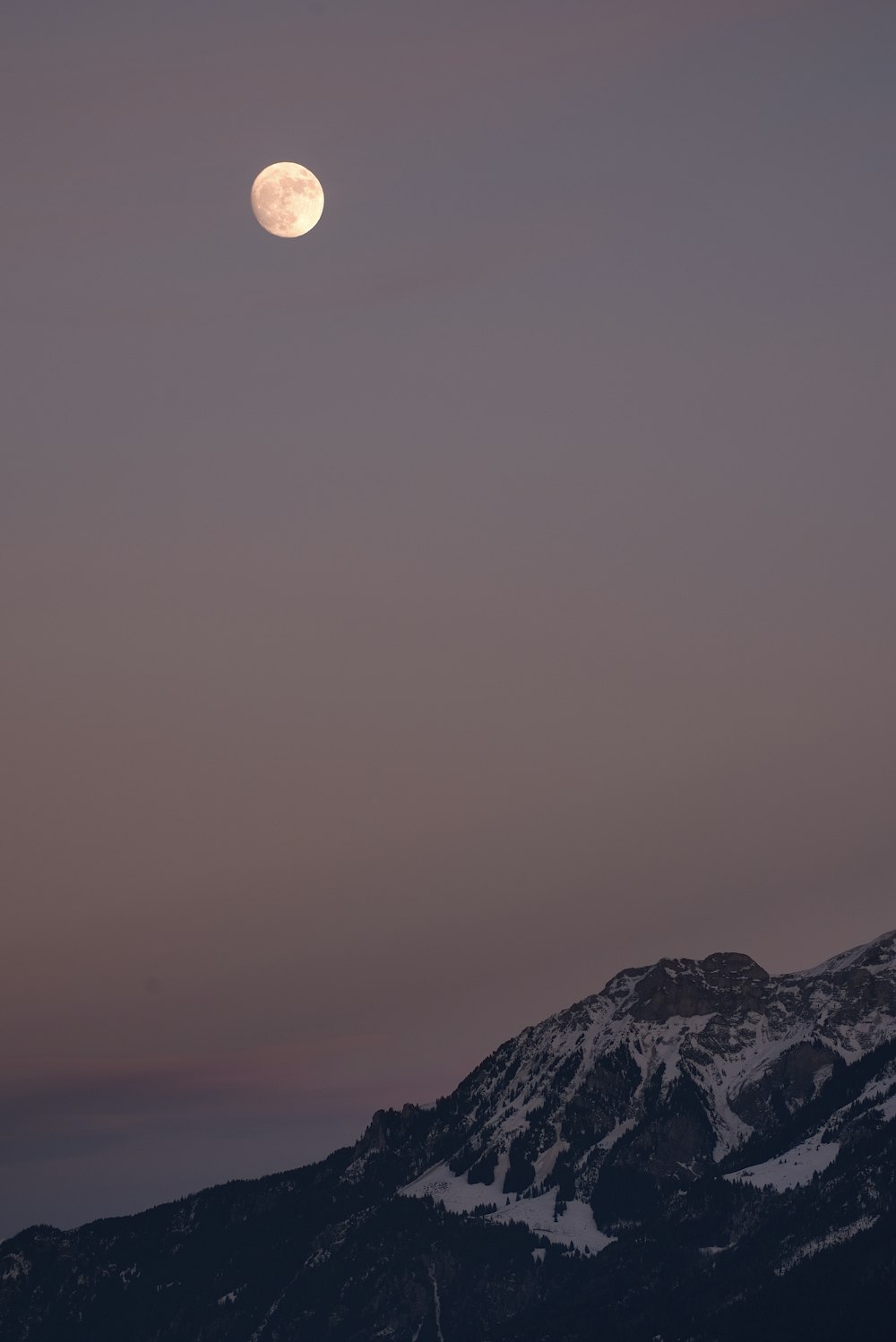 full moon above hill at night