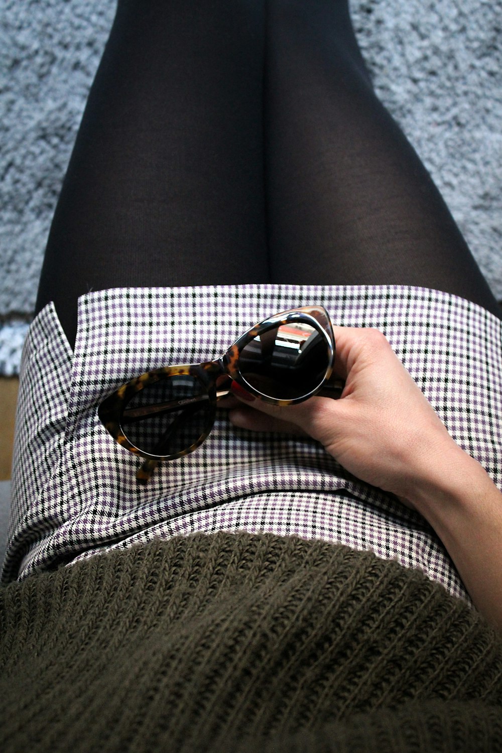 person holding brown sunglasses