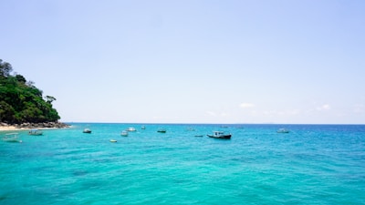 A serene coastal view from Illes Balears with turquoise waters and traditional boats.
